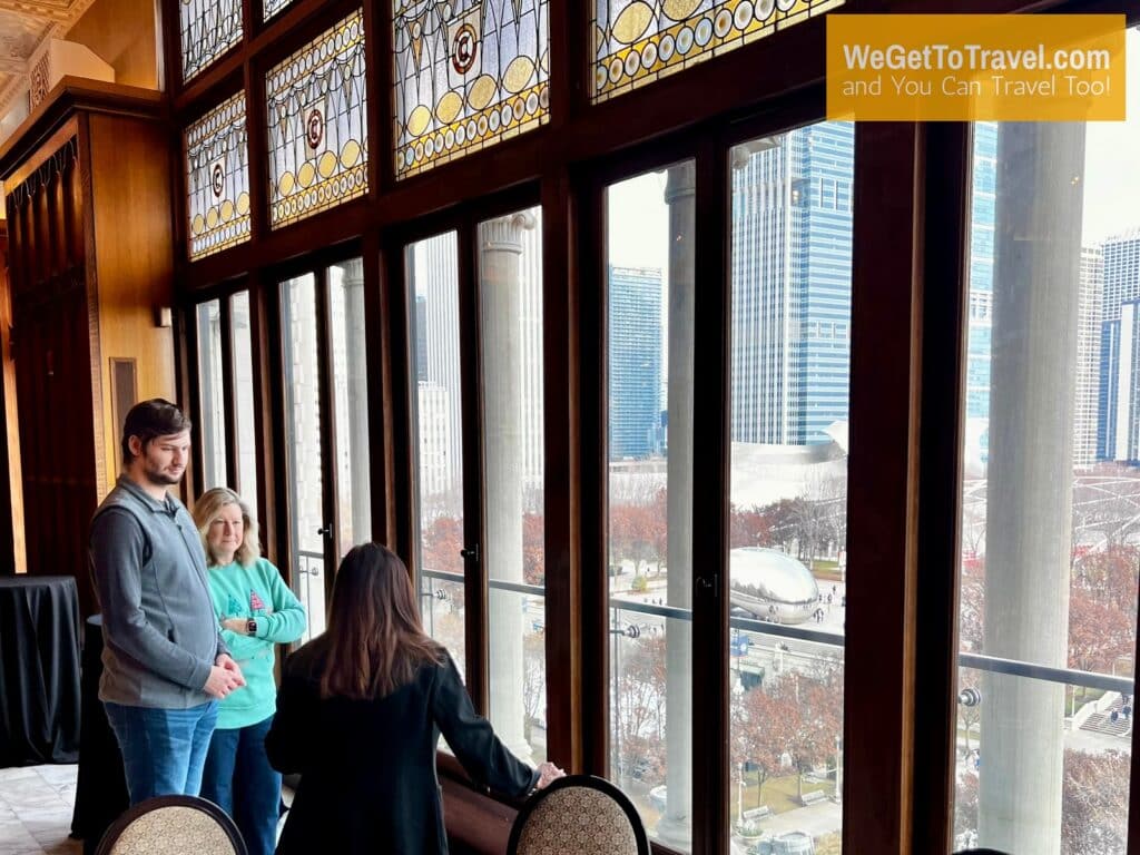 Trent and Sandra tour the ballroom at Chicago Athletic Association hotel with Millennium Park out the window