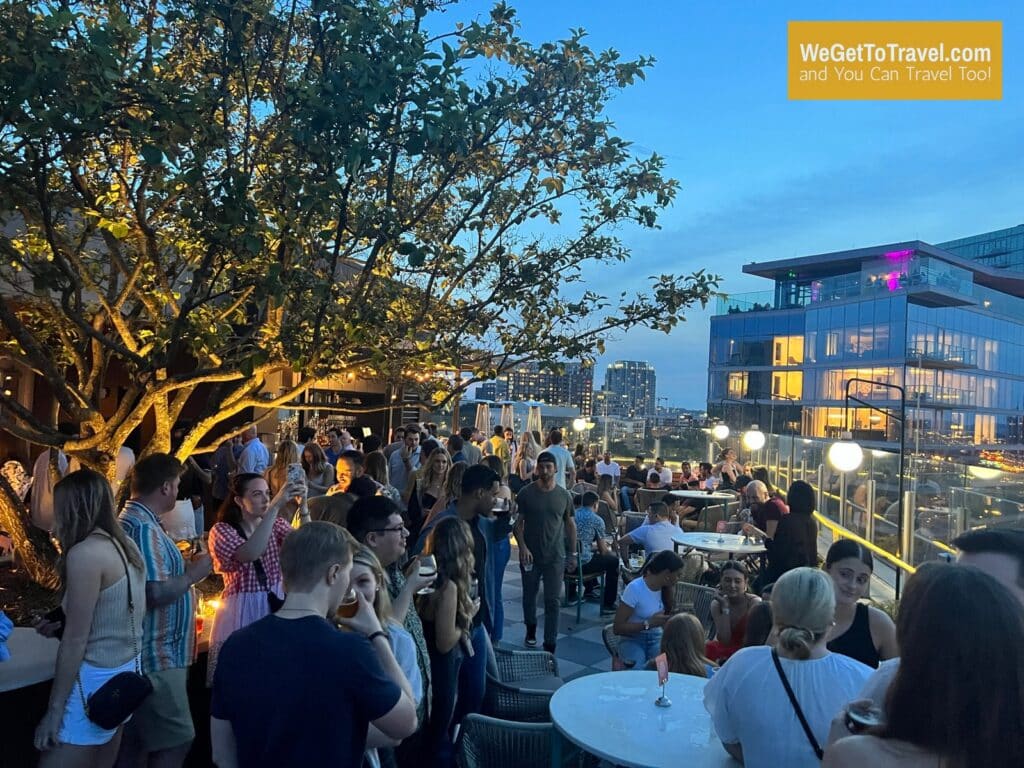 rooftop bar at Thompson Nashville hotel at night with W Hotel in background