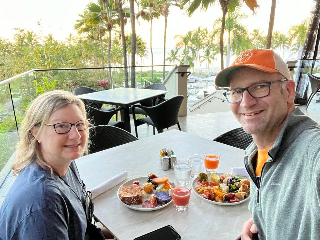 Eating breakfast outside with palm trees at Andaz Maui in Hawaii