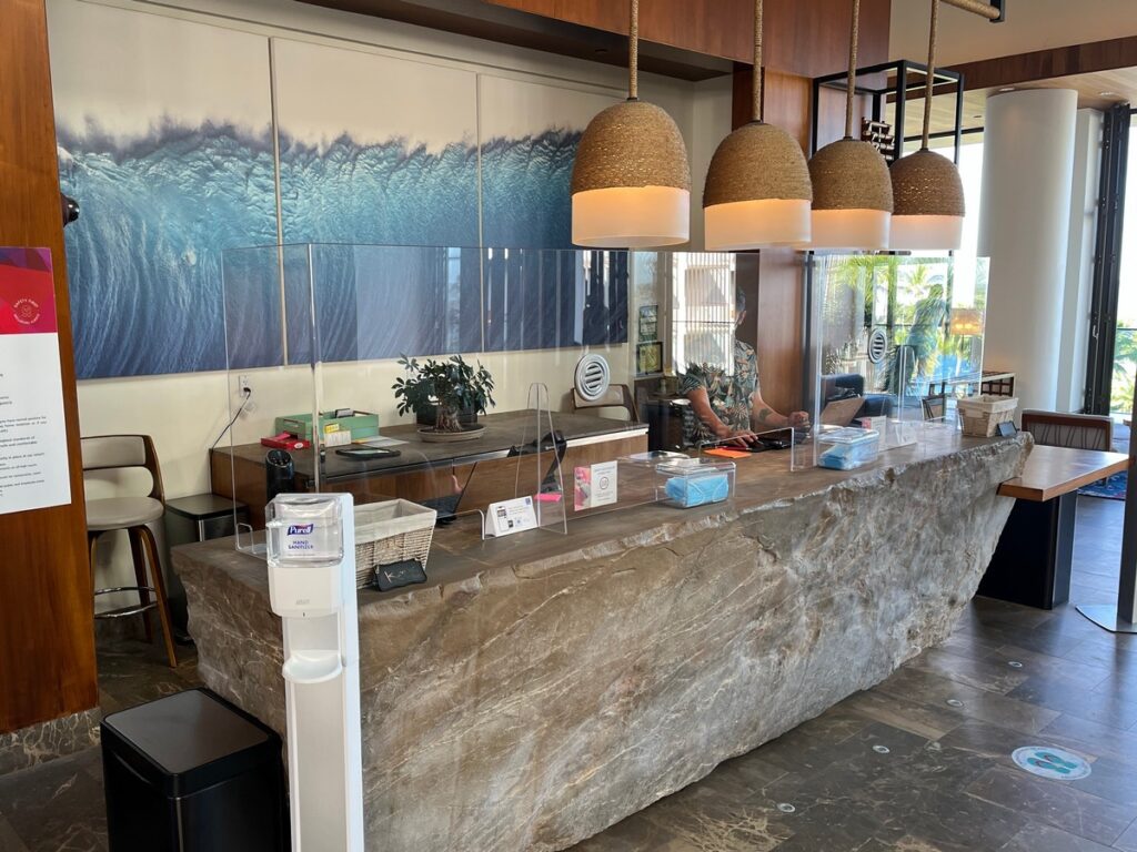 front desk made of stone with plexiglass barriers