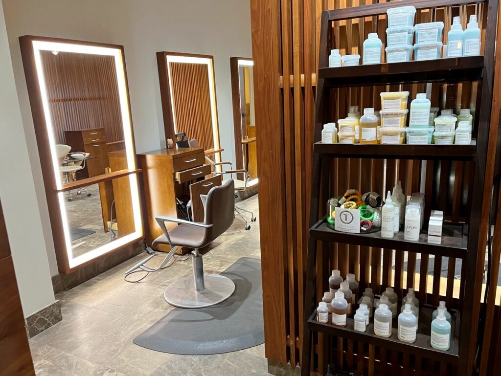 hair salon chair and shelf with products from Davines and Opalex
