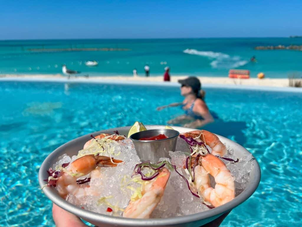 Iced plate with shrimp cocktail and Zuzu in infinity pool at Baha Bay Beach Club