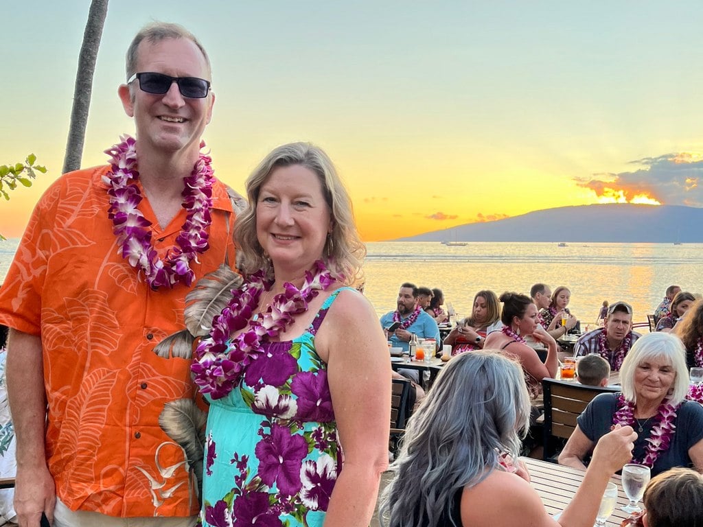 Ross and Zuzu adorned in leis at Feast at Lele Luau at sunset