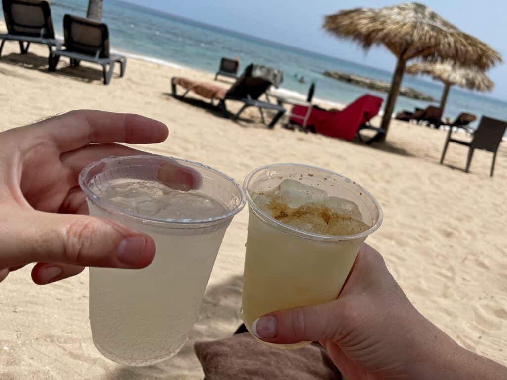 Gin ricky and a painkiller in cups on the beach at Hyatt Zilara in Jamaica