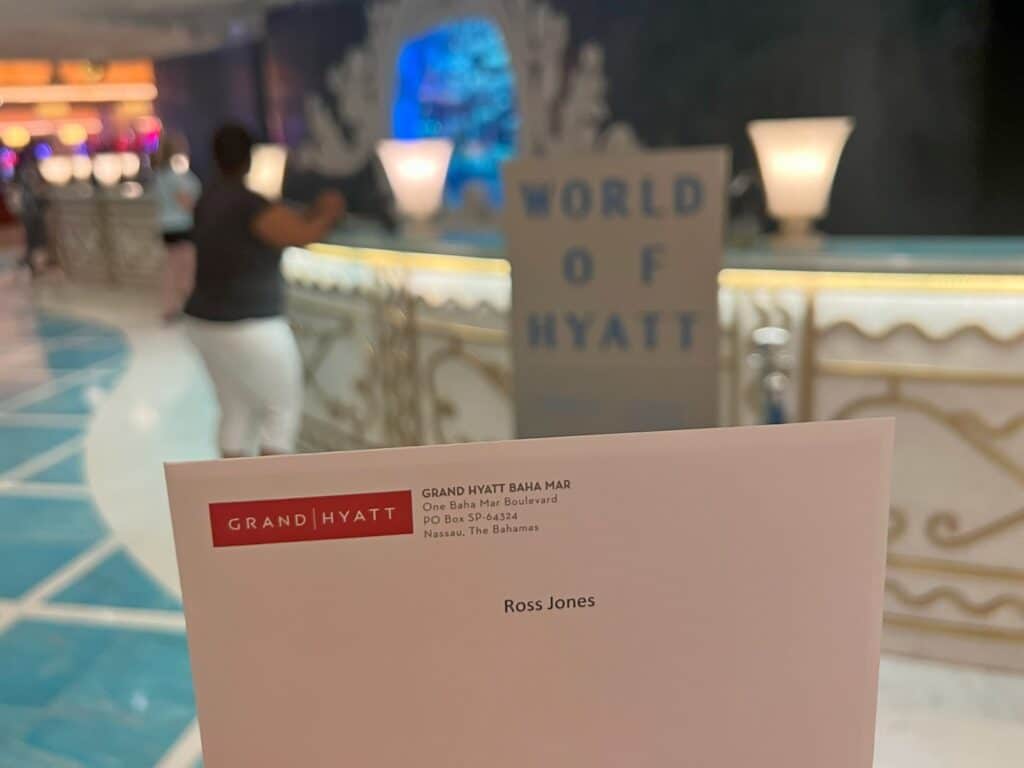 Envelope with Ross Jones name on it with World of Hyatt sign in background