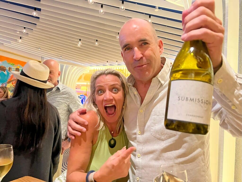 Ellie & Paul showing off a bottle of Submission brand wine at the Jazz Bar in Grand Hyatt Baha Mar
