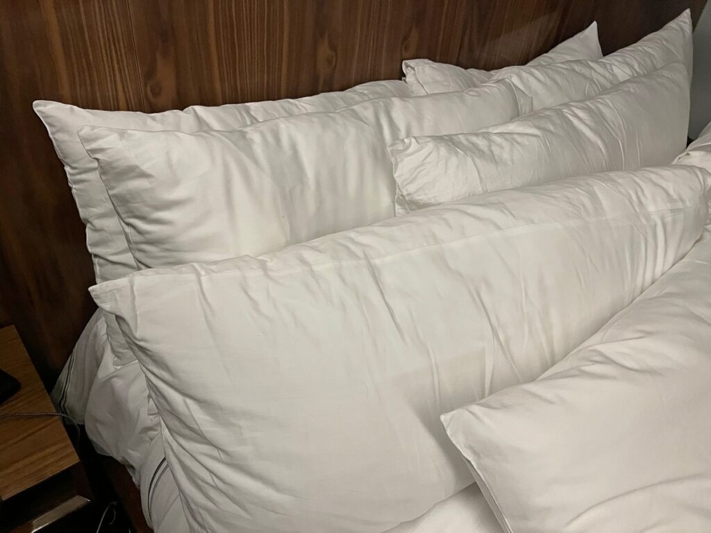 Lots of uncomfortable pillows on this bed at the Grayson Hotel.