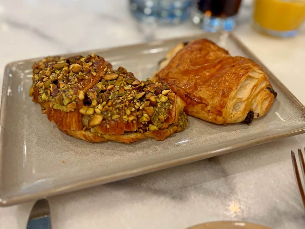 Picture of the pistachio berry croissant which was the best thing we ate on our NYC trip next to an unforgettable chocolate croissant.