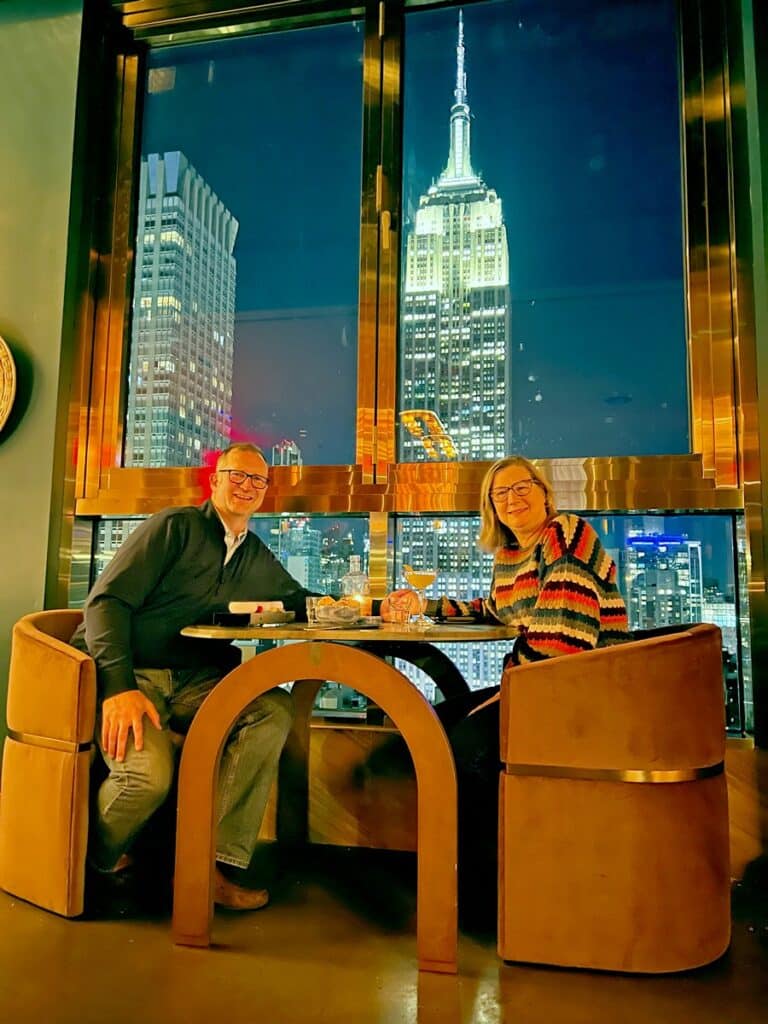 Ross & Sandra at Cima Rooftop Bar at Grayson Hotel with Empire State Building ion background