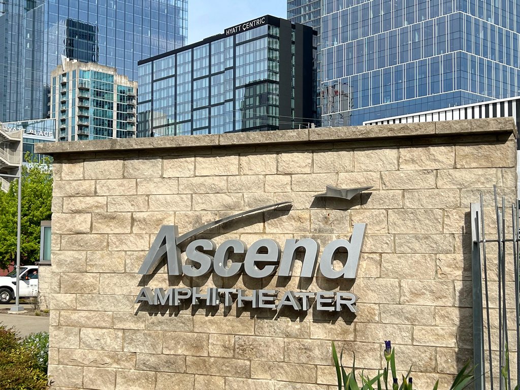 Ascend Amphitheater sign with Hyatt Centric in background.