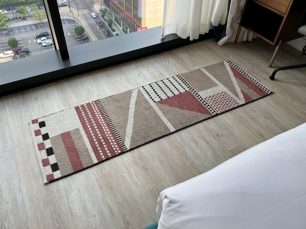 Floor rug with geometric shapes.