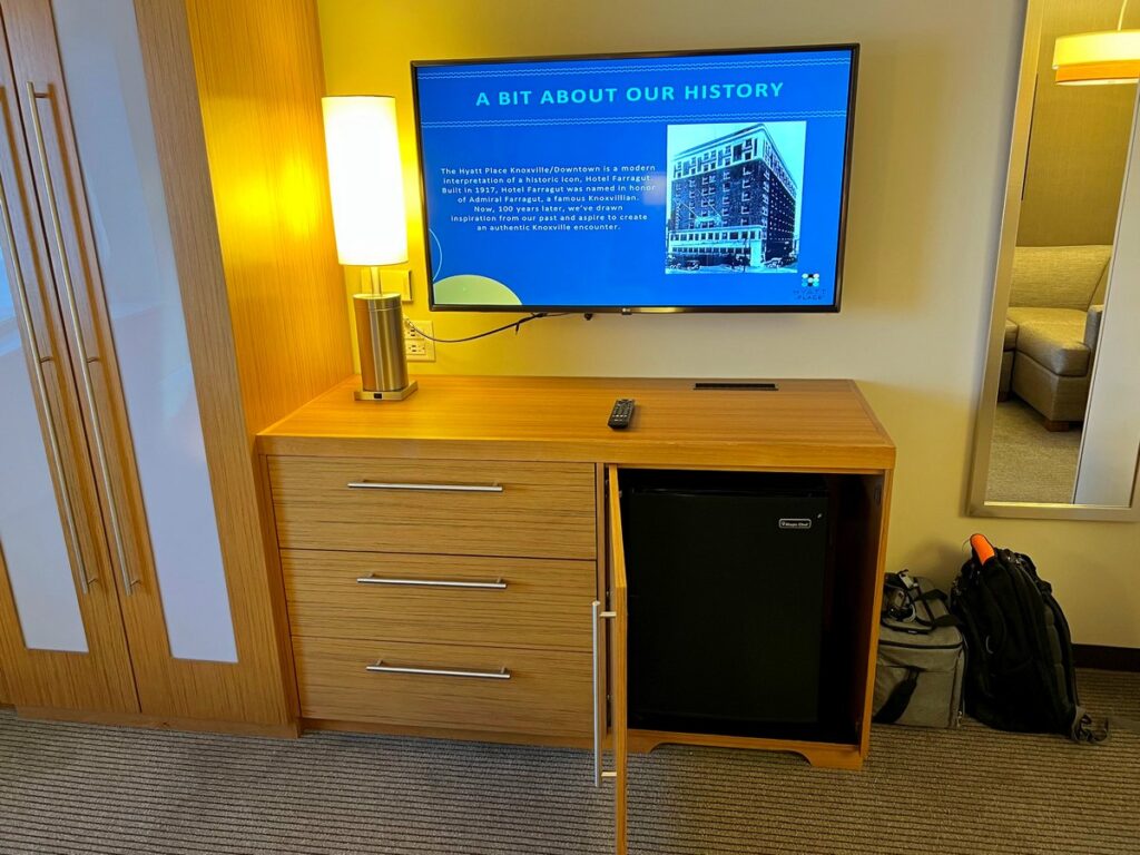 TV, dresser, mirror and mini refrigerator at Hyatt Place Knoxville