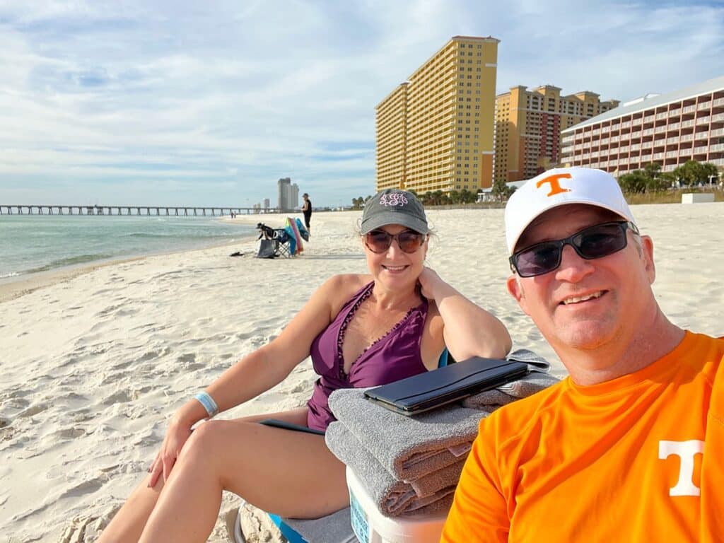 Ross & Zuzu on Panama City Beach with beach, water, pier and buildings in the background.