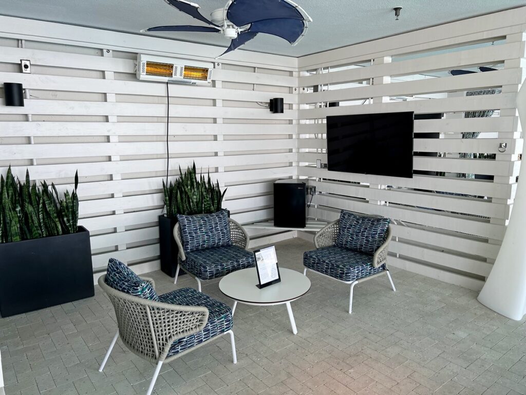 pool cabana with 3 chairs, TV, mini fridge, heater & ceiling fan at the Hyatt Place Panama City Beach