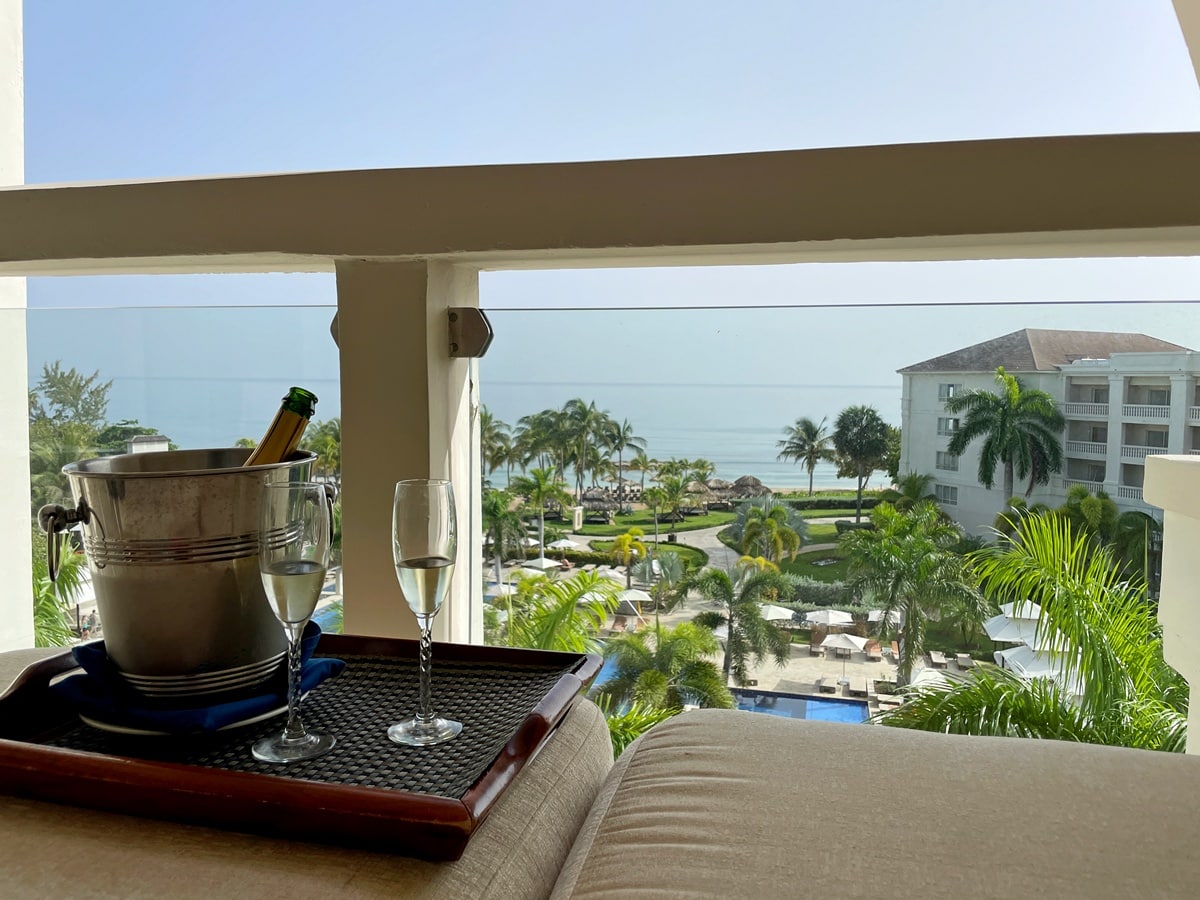complimentary champagne bottle and flutes on Hyatt Zilara Rose Hall balcony with beach and water in the background