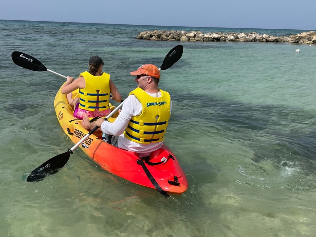 Ross & Zuzu wearing lifejackets while padding a kayak at Hyatt Zilarra Rose Hall in Jamaica