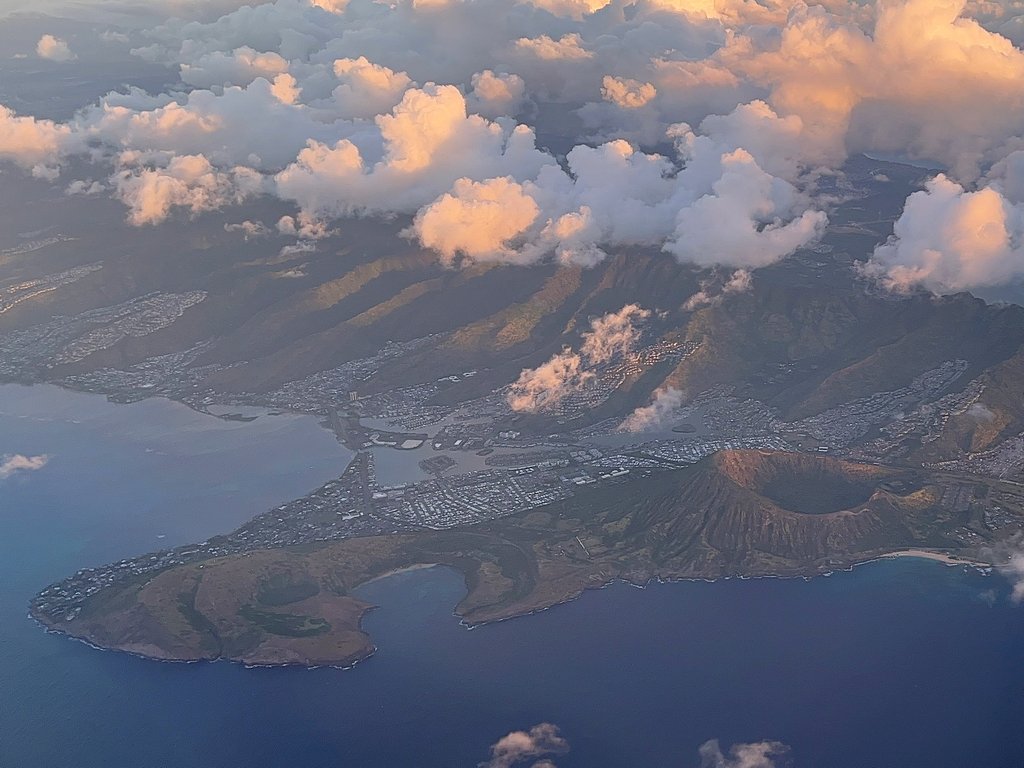 View from airplane of Clouds over Diamondhead and Waikiki Beach in Honolulu