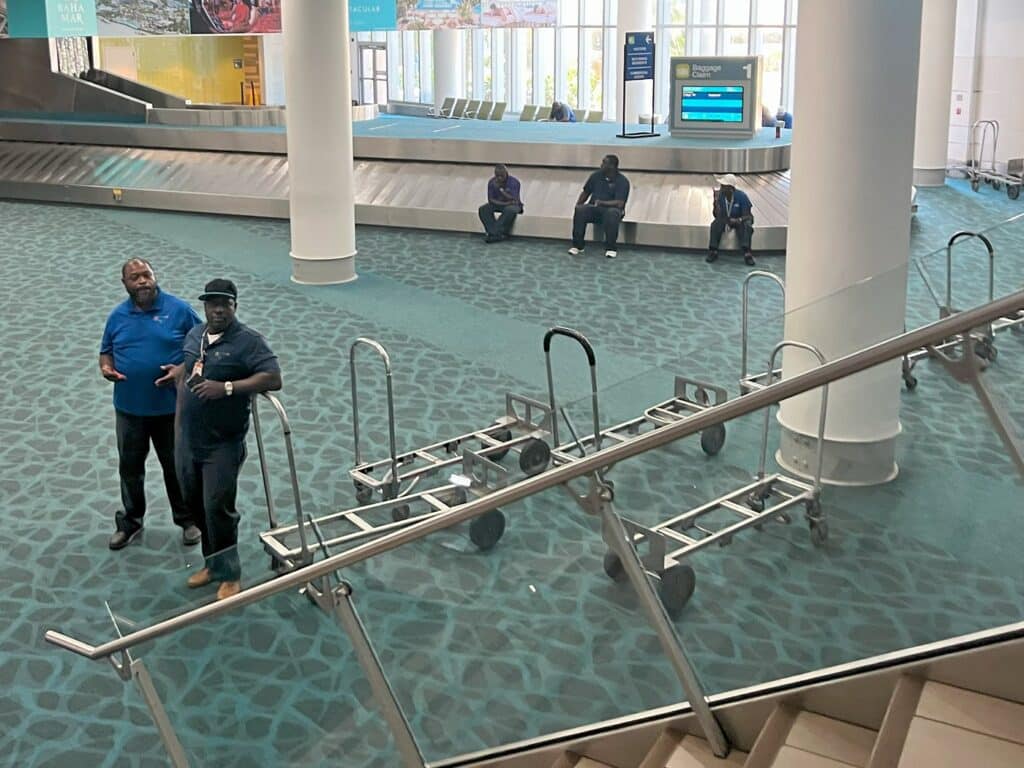 porters waiting in baggage claim in LPIA