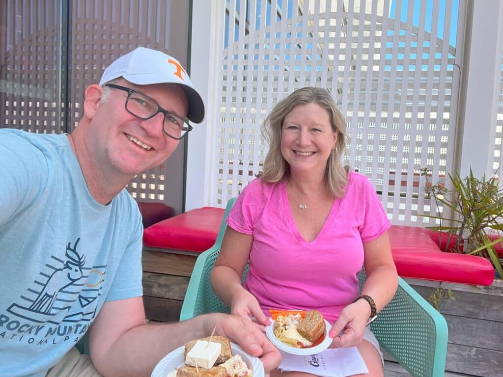 Ross & Zuzu eating outside at the Priority Pass Graycliff Lounge in Nassau Airport