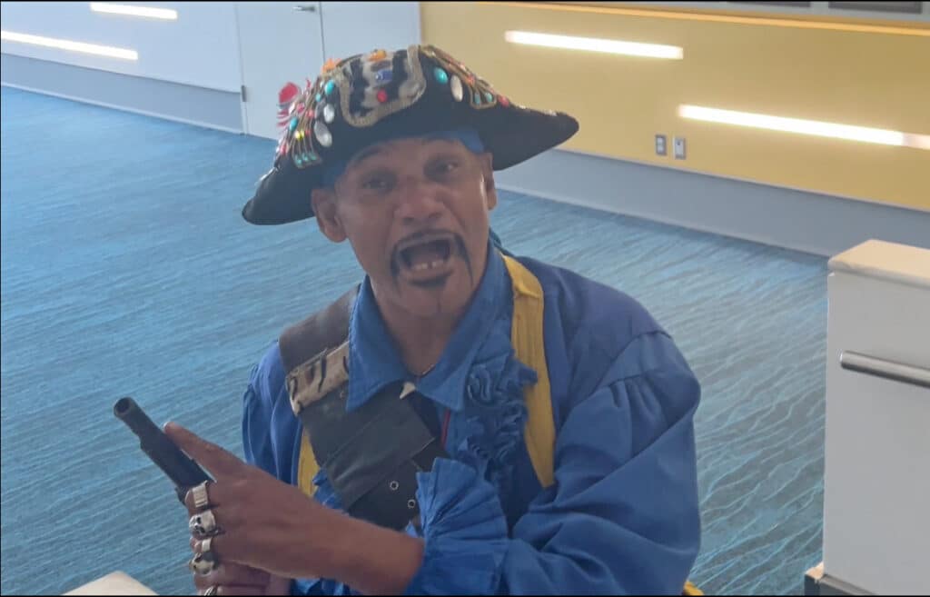 pirate in Nassau Airport pointing to his flintlock pistol