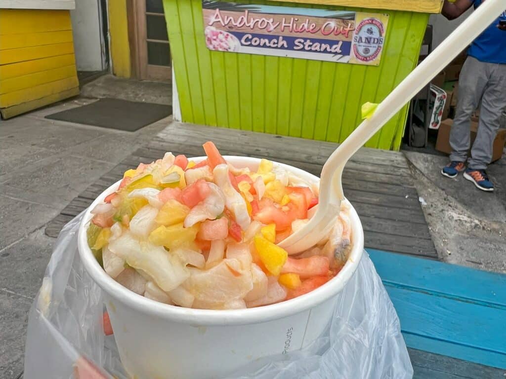 Spoon in a quart of fresh conch salad at the Fish Fry in Nassau.