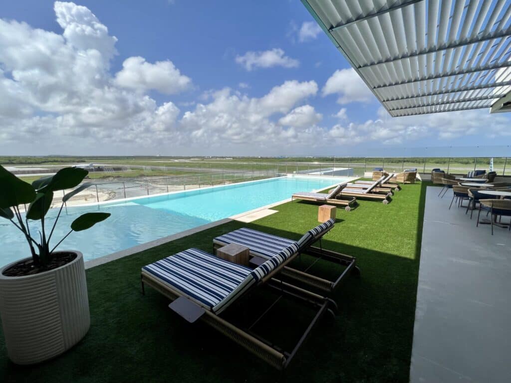 VIP Lounge swimming pool and deck with chairs overlooking the runway at Punta Cana Airport