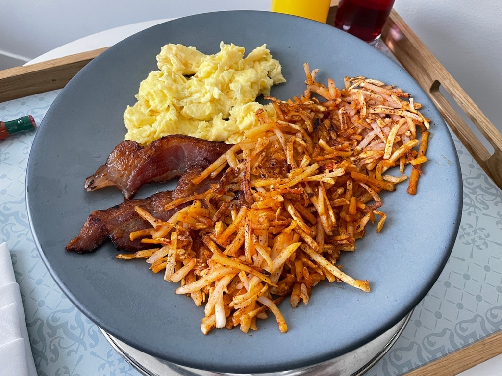 room service plate with eggs bacon and hash browns