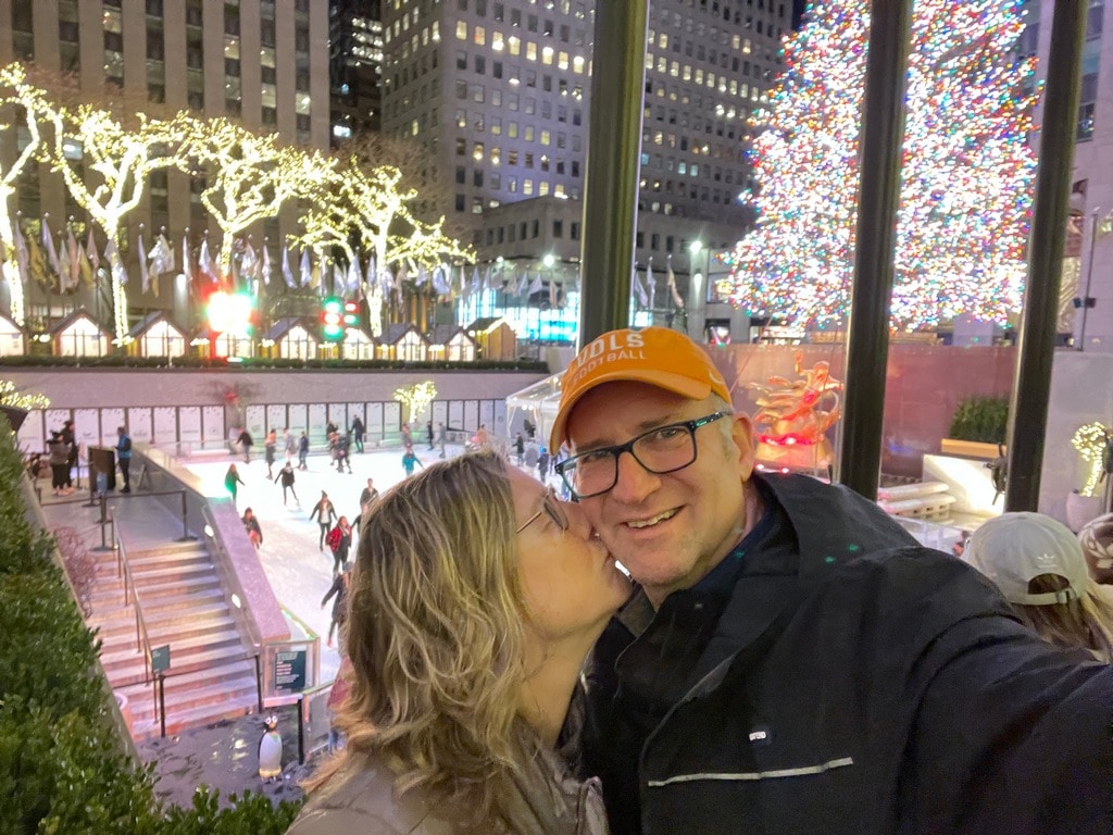Zuzu kissing Ross at Rockefeller Center on our free Holiday trip to NYC