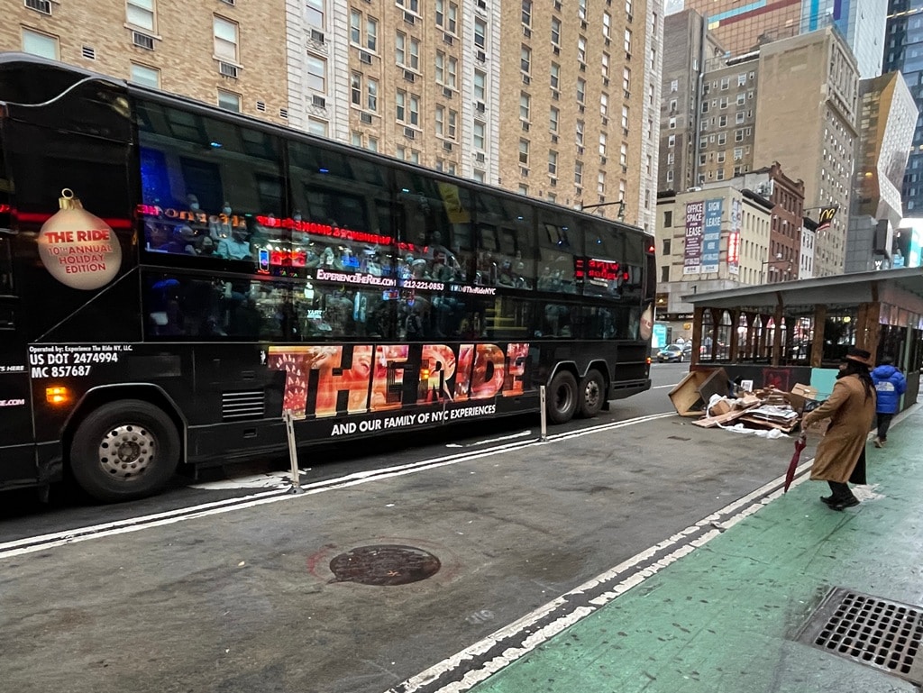 NYC The Ride Bus with Street Performer Tiny Tim in Top hat