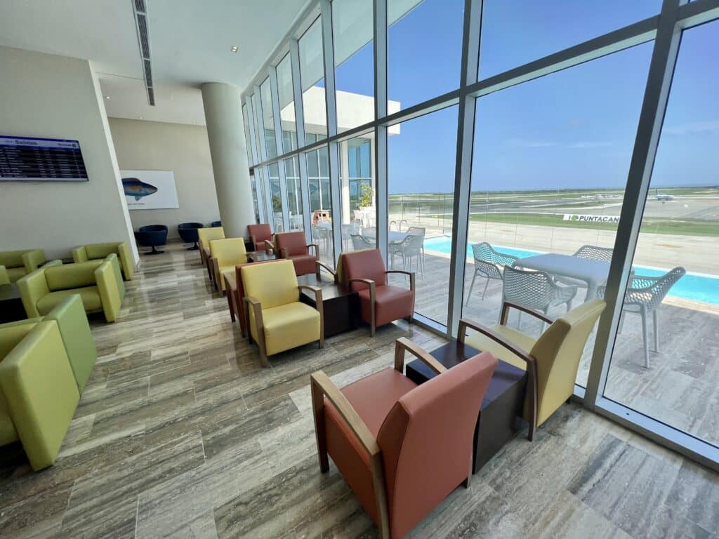 Chairs in PUJ lounge with swimming pool out the windows