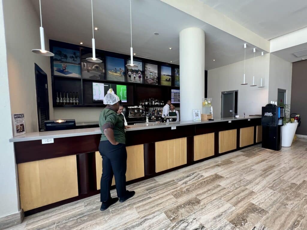 Staff in front and behind the bar at VIP Airport Lounge in Punta Cana