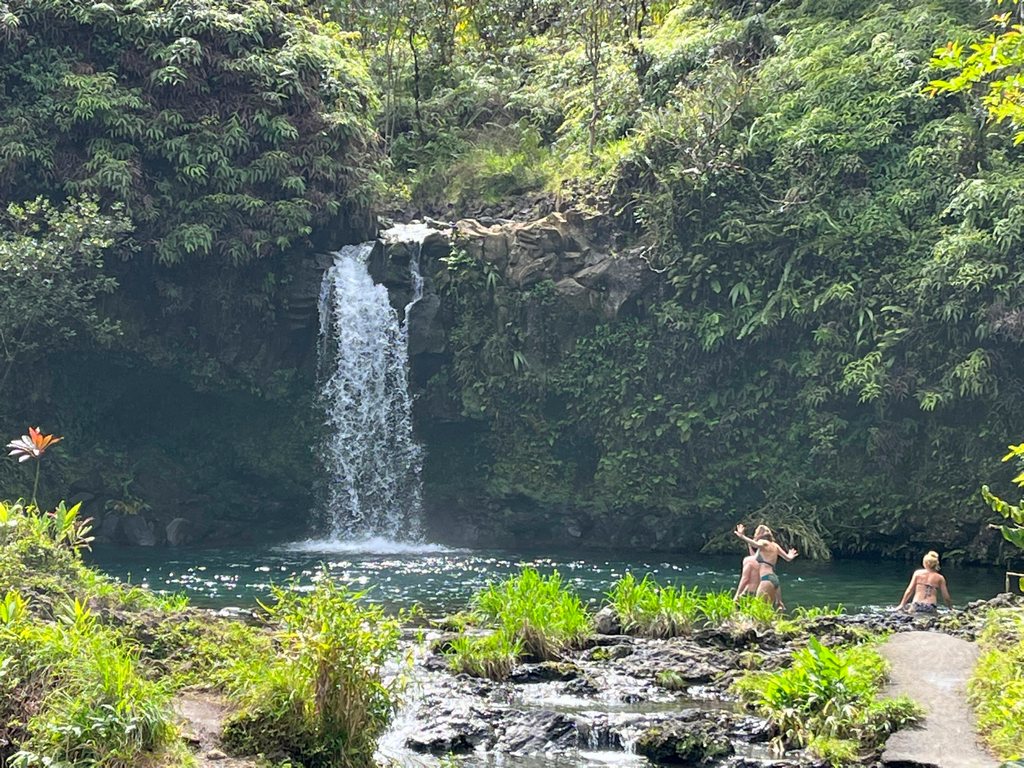 swimmers near waterfall at Pua'a Ka'a Park on the Road to Hana