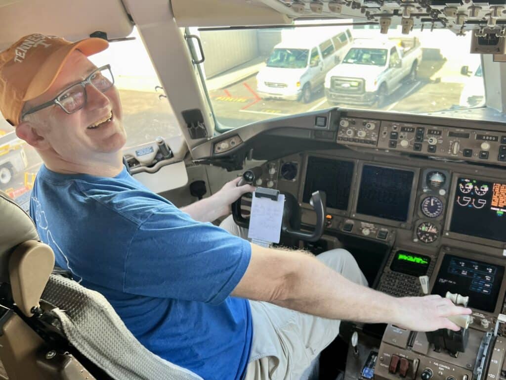 Ross at controls of Delta 767 cockpit