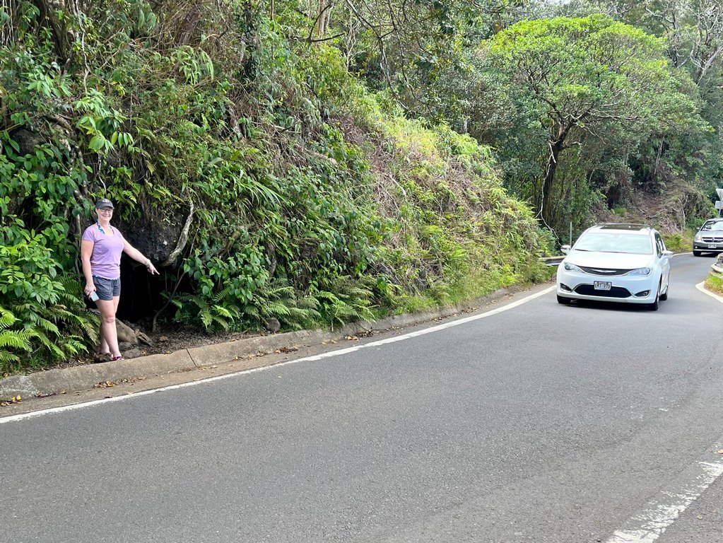 Zuzu pointing to secret lava cave entrance that isn't listed in most Road to Hana Guides