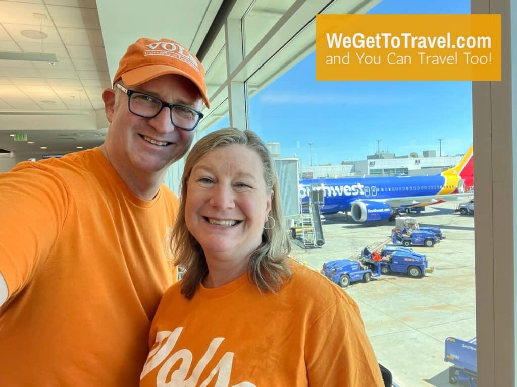 Ross and Zuzu wearing orange to support our TN Vols football team with a Southwest 737 in the background