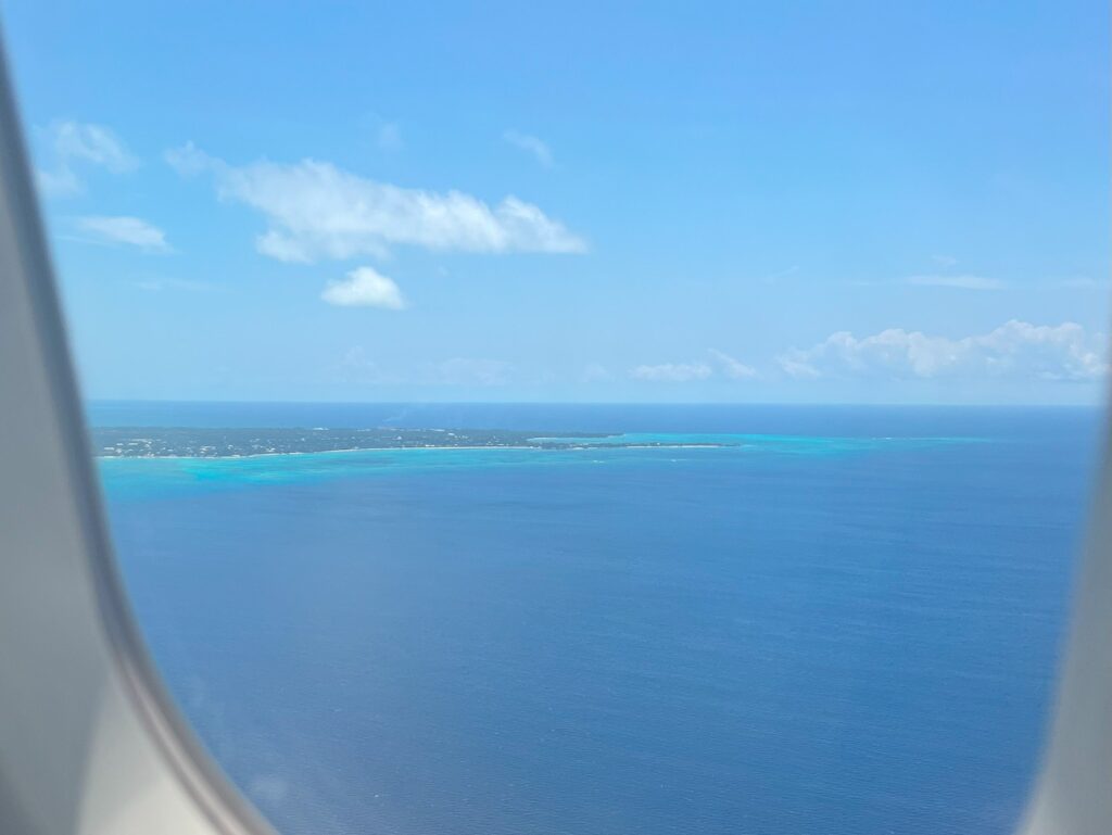 view from airplane window of blue water, white sand beaches as we approach Nassau Airport