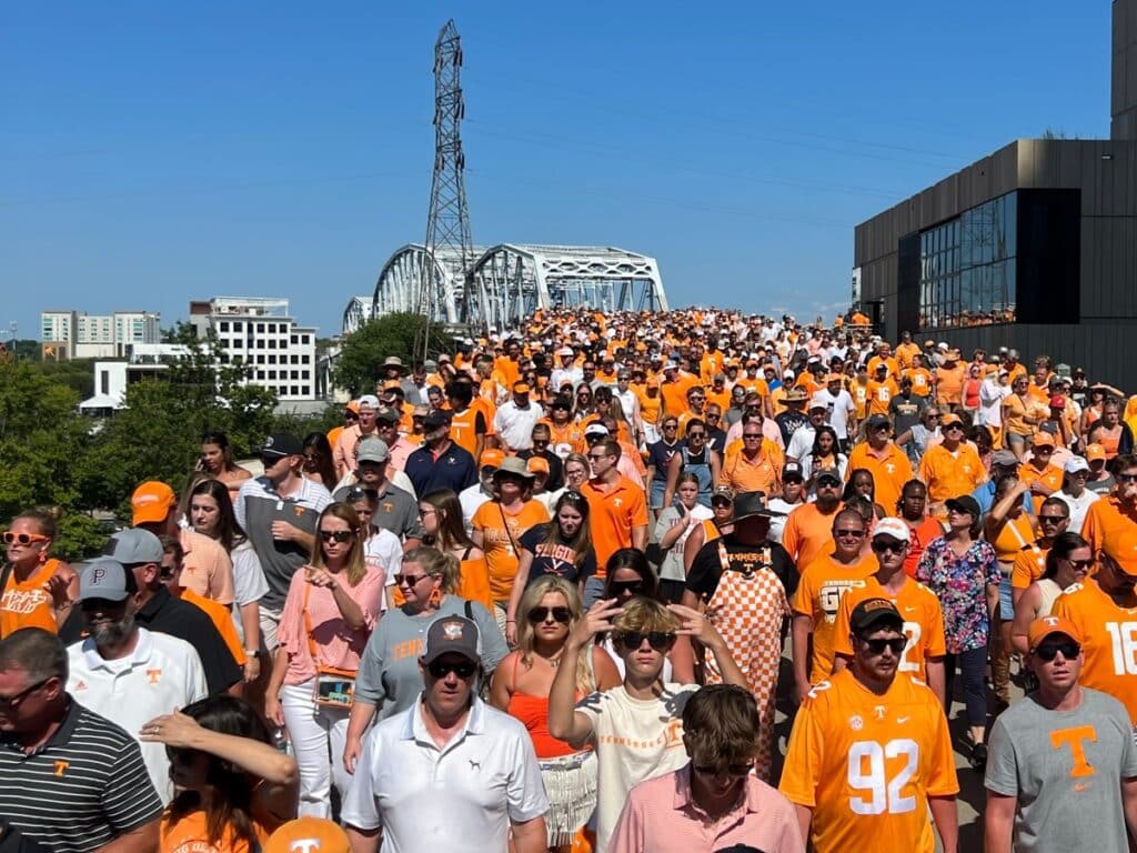 Crown of Tennessee Vol fans on the pedestrian bridge after a football game in Nashville