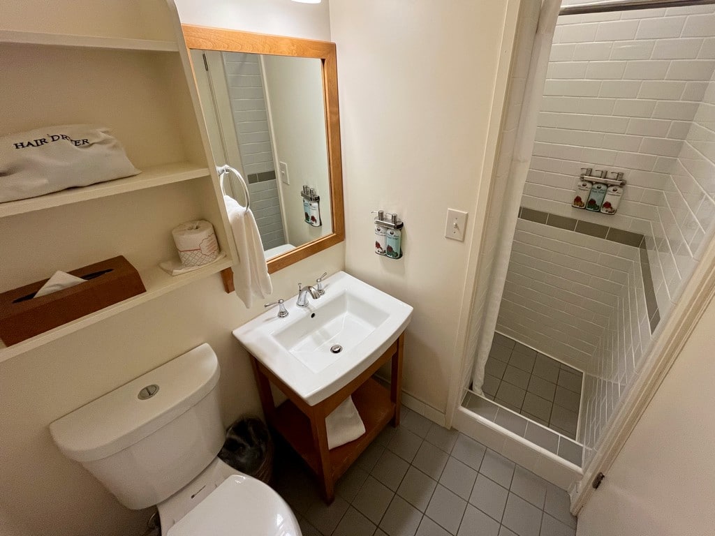 Bathroom with walk in shower in Deluxe Crater View Room at Volcano House Hotel Hawaii.